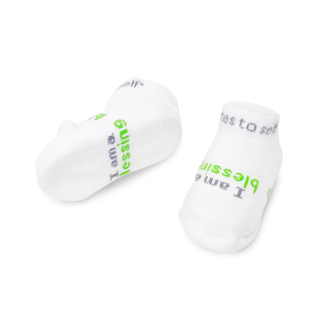 I am a blessing® white baby socks with green words (3-12 mo)